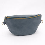 Blue suede fanny pack with gold zipper on a white background